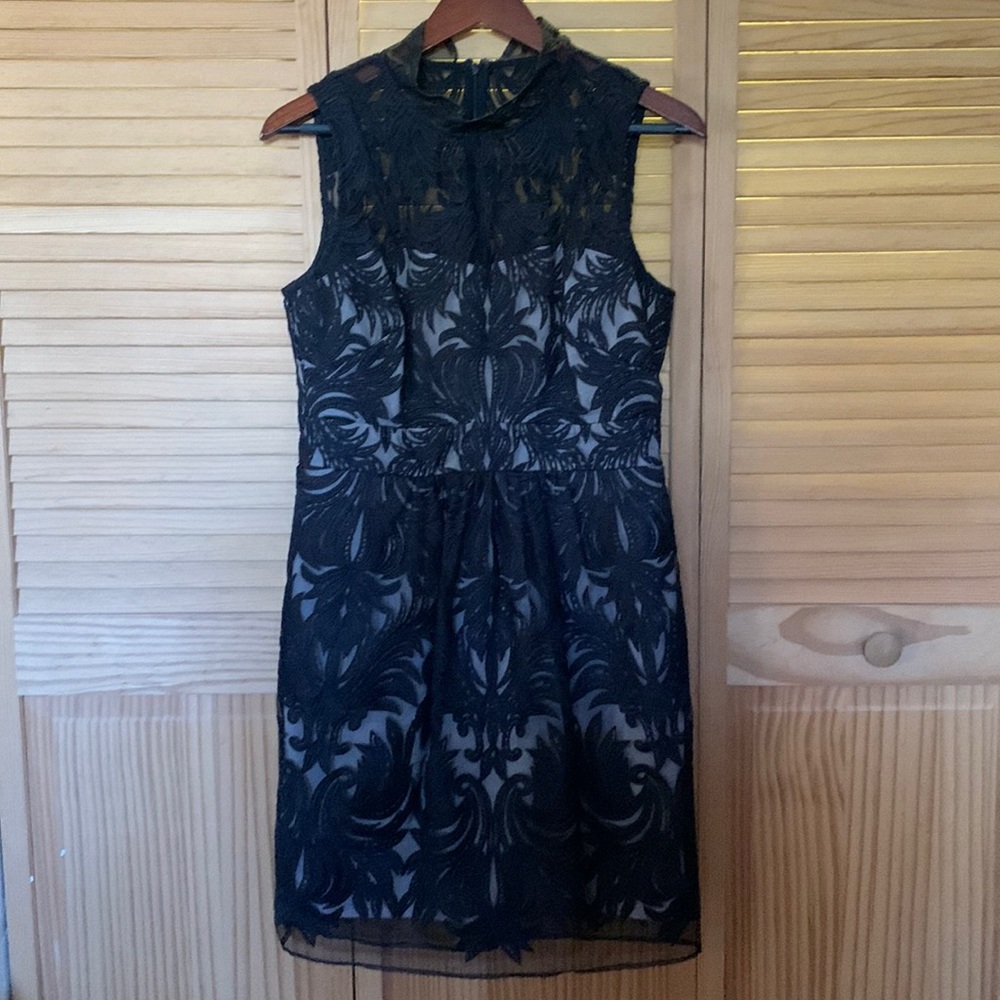 Beautiful black lace over cream lining sleeveless dress.